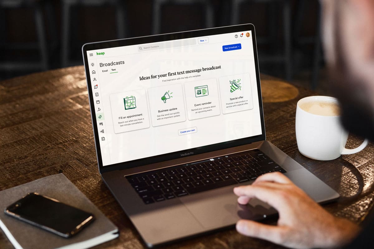 Laptop displaying an email and SMS broadcast automation dashboard used for customer communication and marketing campaigns