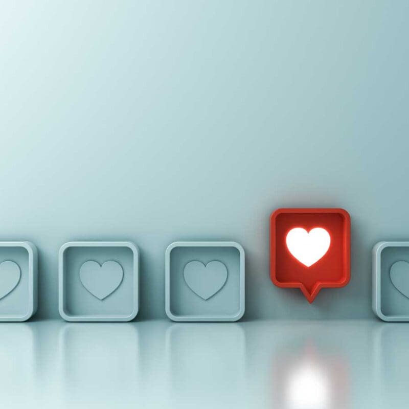 Social media engagement icons with a highlighted heart notification representing audience interaction
