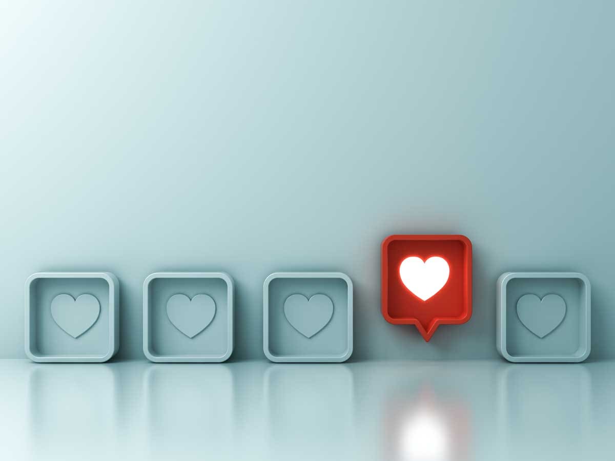 Social media engagement icons with a highlighted heart notification representing audience interaction