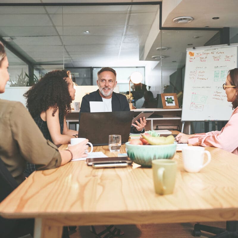 An office with the Social media team working and discussing blog content