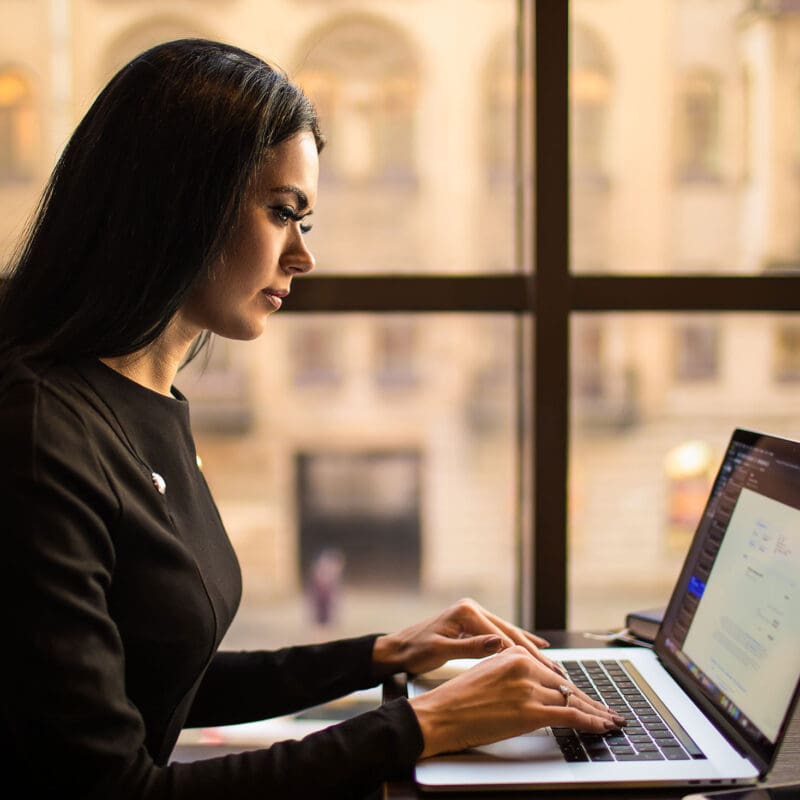 Woman working on writing a blog to increase her business' SEO Presence