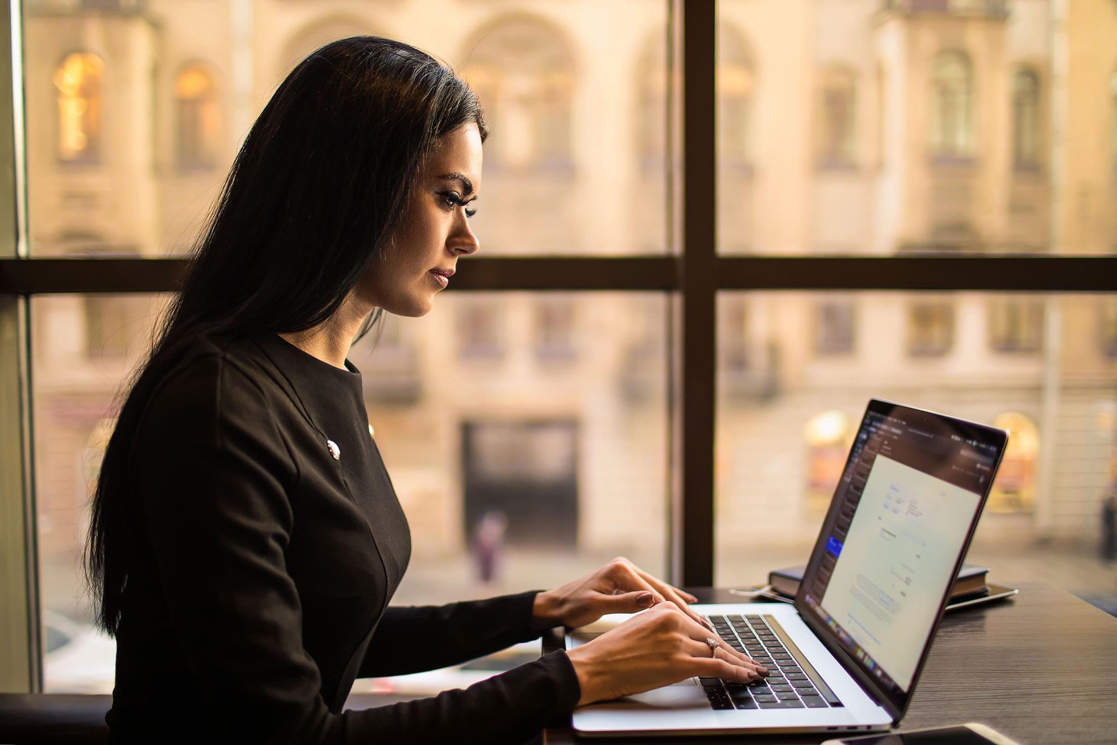 Woman working on writing a blog to increase her business' SEO Presence