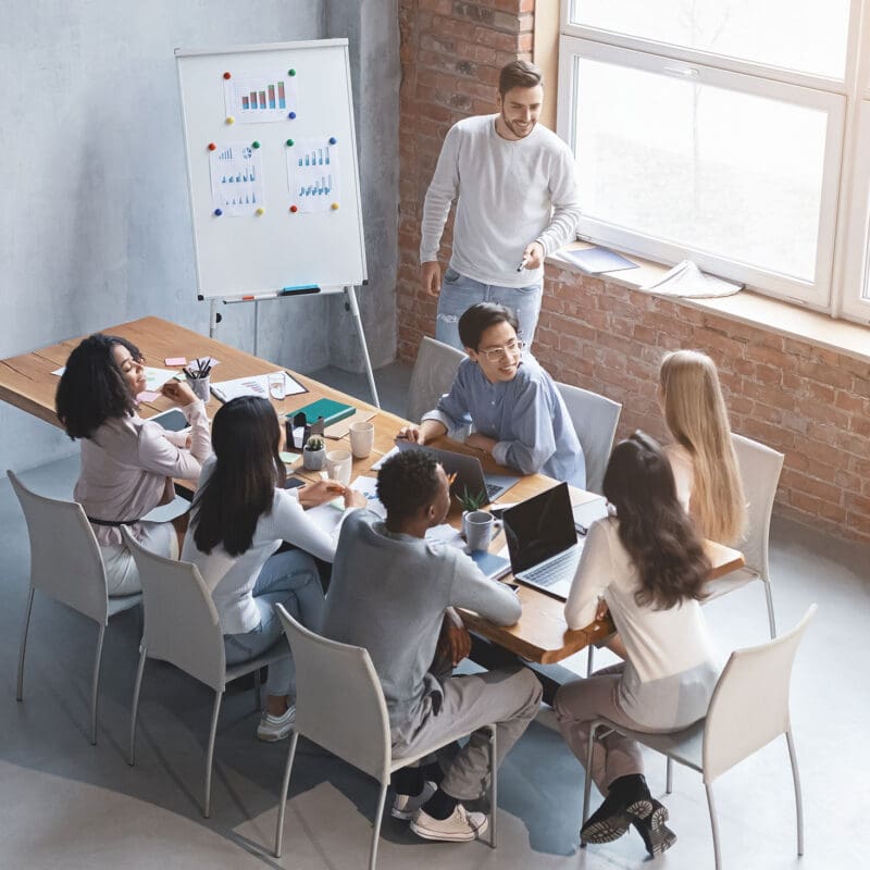 Creative marketing team collaborating in a strategy meeting around a conference table