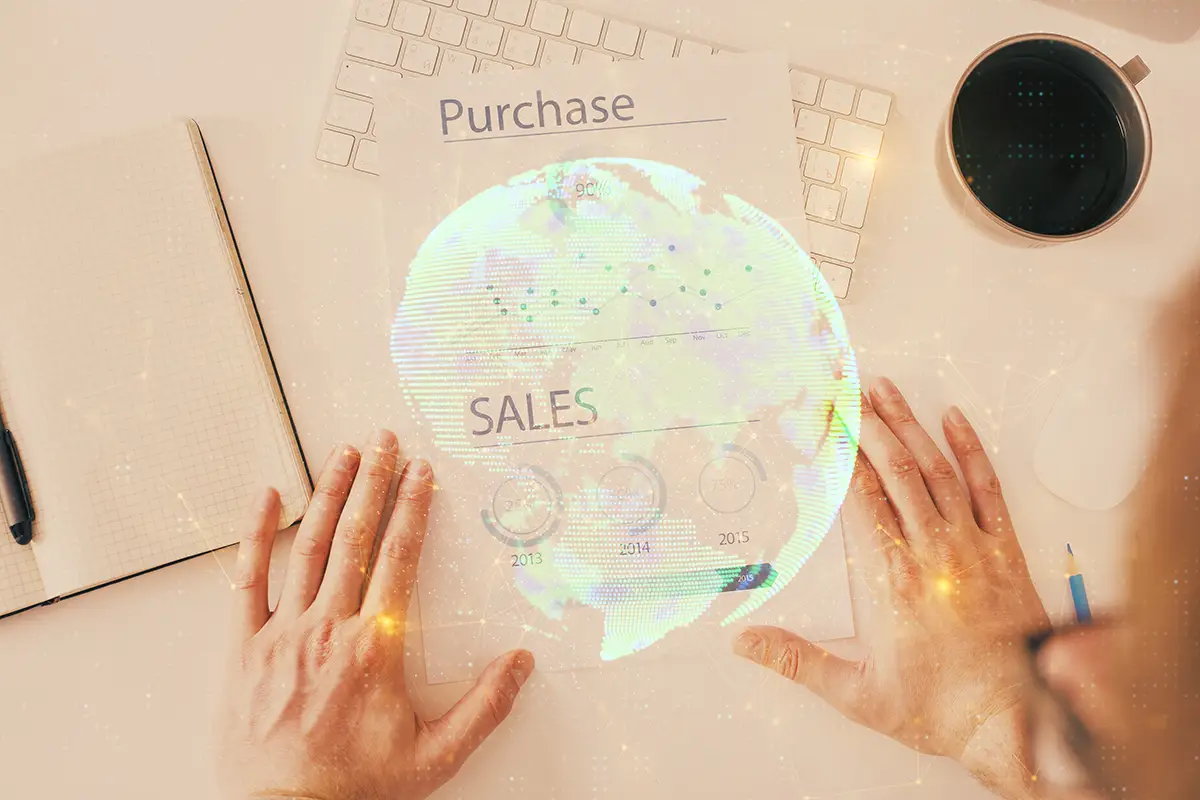 Sales and purchasing objectives with a keyboard, notepad and coffee