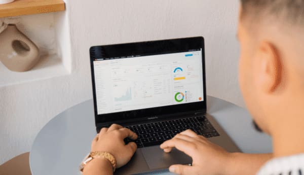 Professional reviewing analytics dashboard on laptop during performance analysis