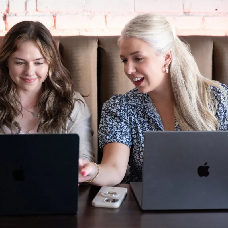 Team collaborating on logistics website development and SEO improvements using laptops