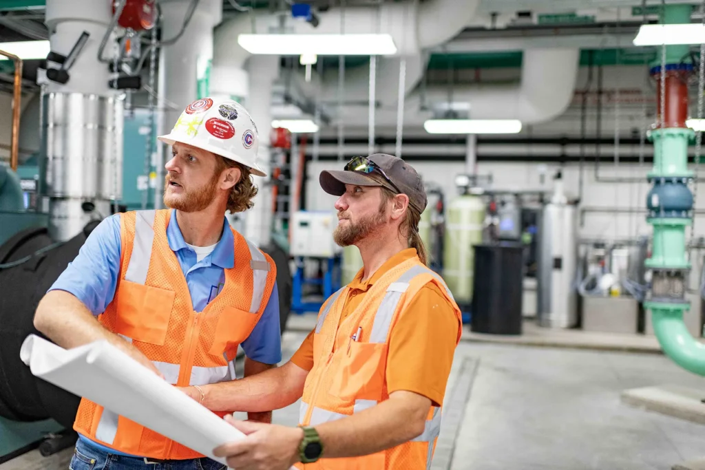 HVAC Testing and Commissioning by Southern Independent Testing Agency SITA technicians reviewing mechanical plans during HVAC testing and commissioning in a commercial facility