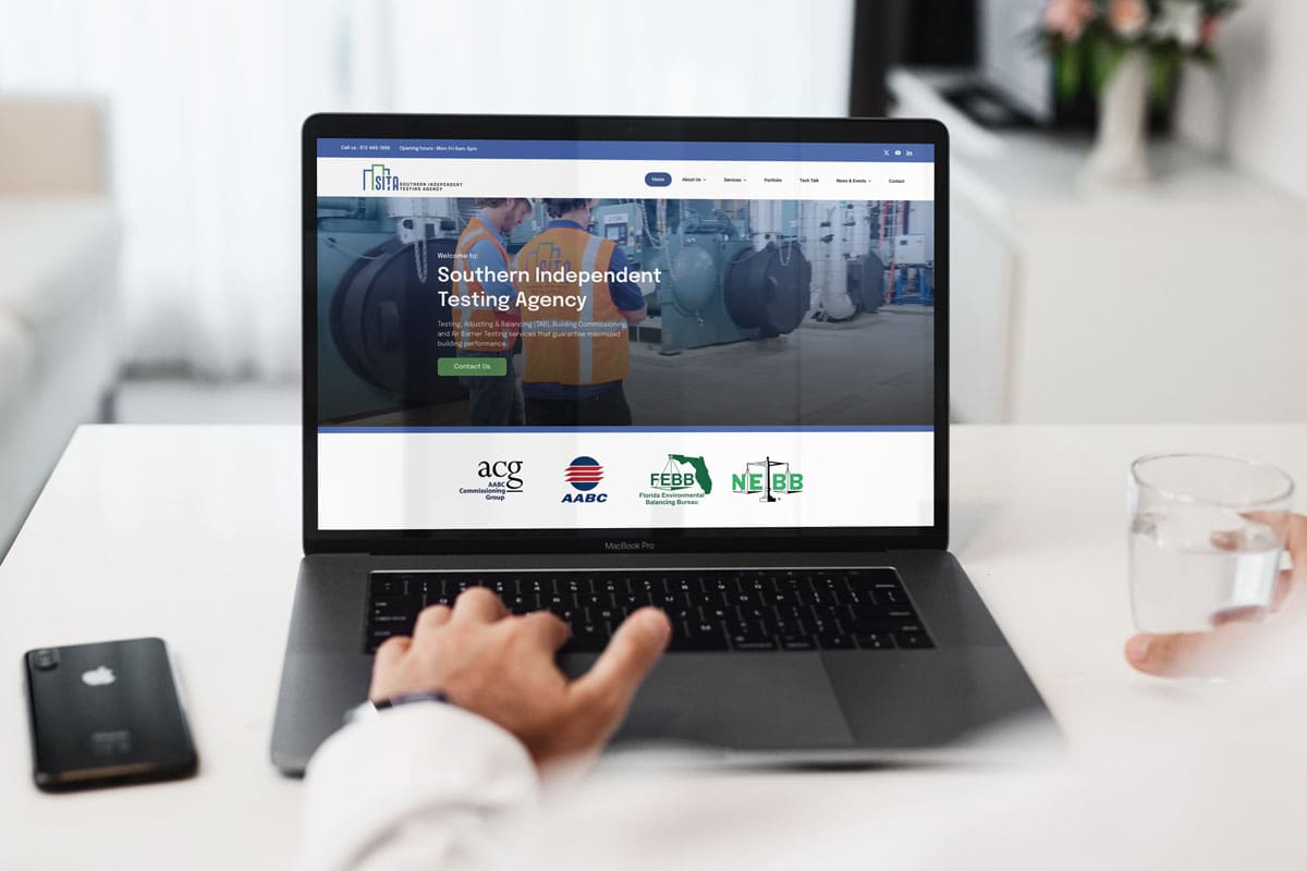 Laptop displaying the redesigned SITA Southern Independent Testing Agency website for HVAC testing and commissioning services