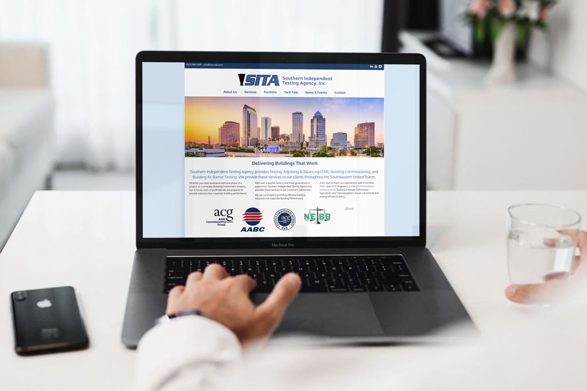 Laptop displaying the SITA Southern Independent Testing Agency website for HVAC testing and commissioning services