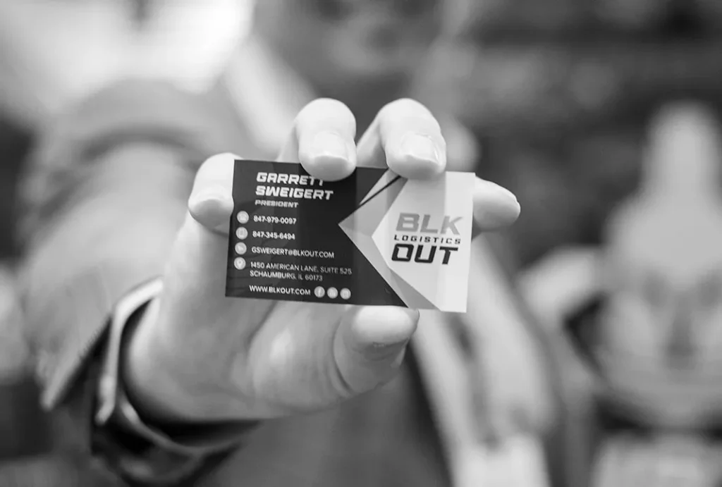 BLKOUT Logistics Business Card Close Up BLKOUT Logistics business card held in hand showing brand identity and contact details