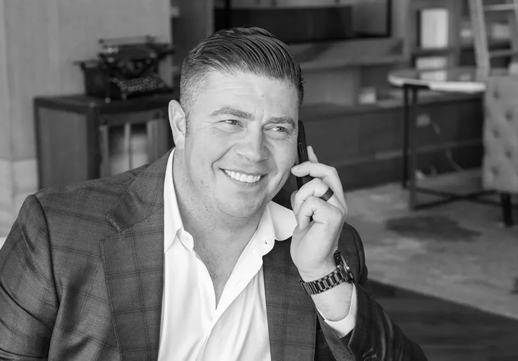 Professional Business Consultation Call Professional smiling man speaking on a phone in a modern office setting