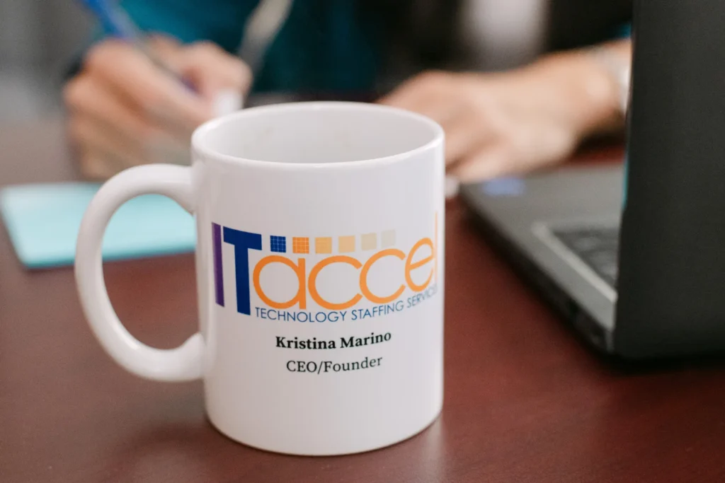 ITAccel Technology Staffing Leadership Mug ITAccel branded coffee mug on desk during technology staffing and consulting meeting