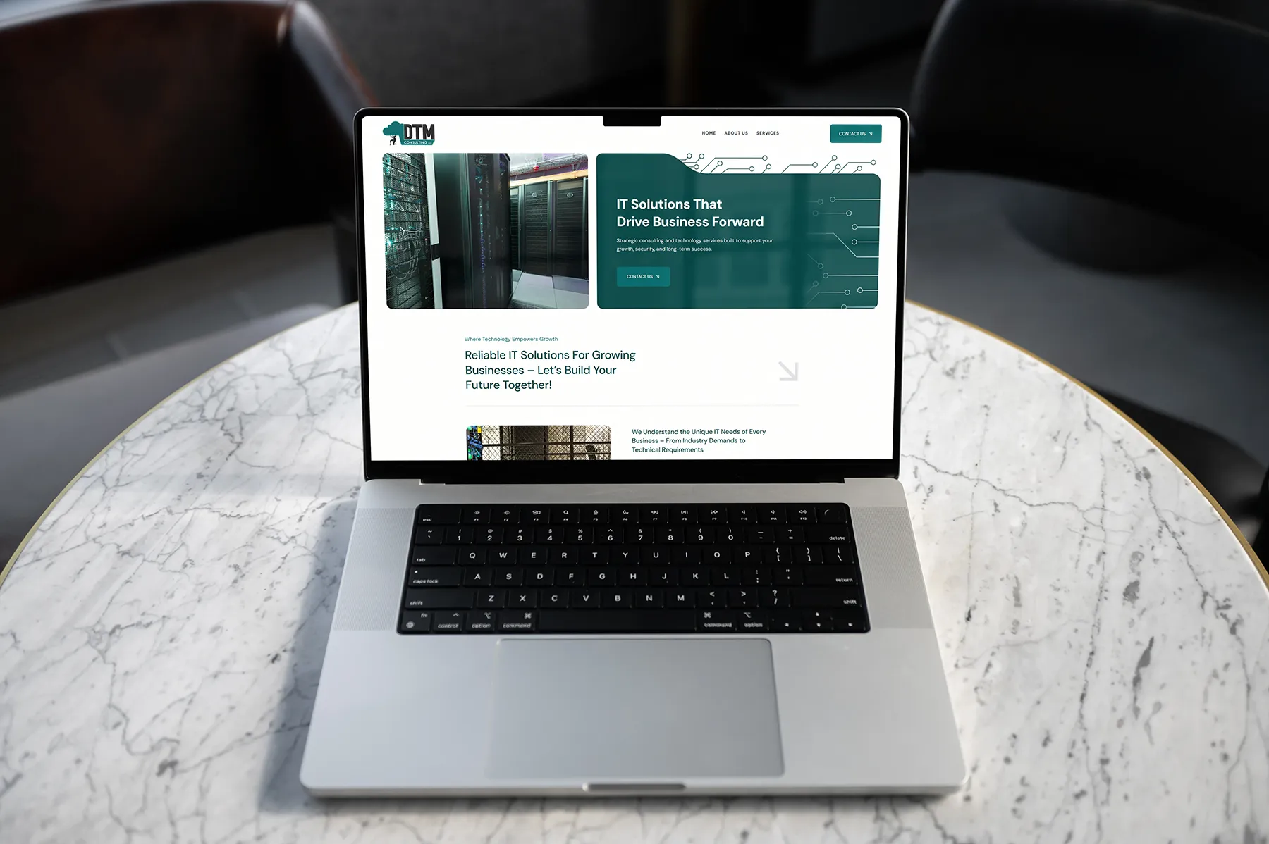Redesigned DTM Consulting website displayed on laptop highlighting IT solutions for businesses