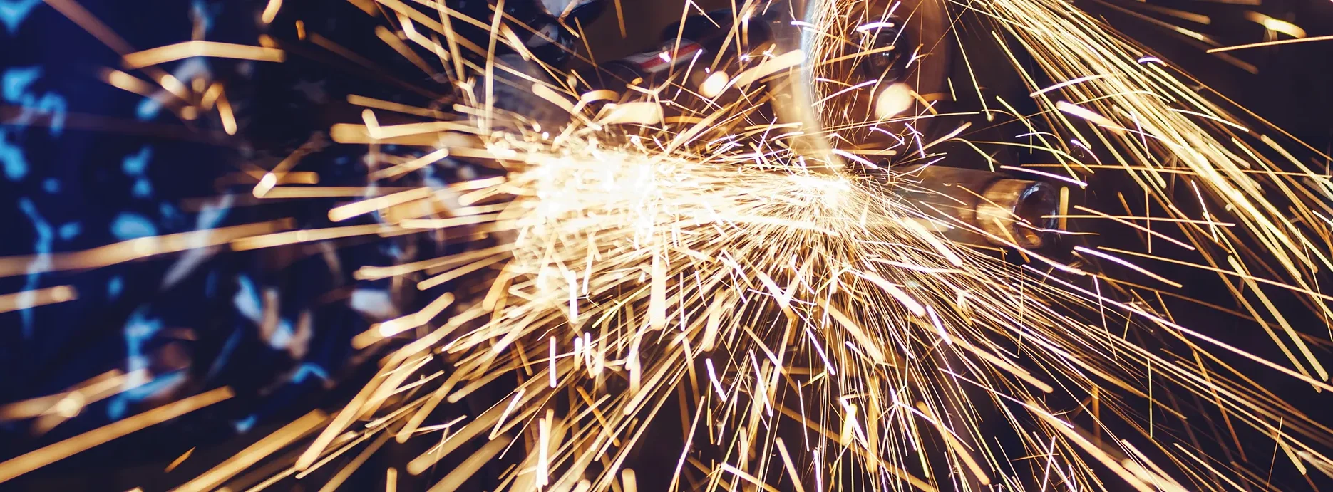 Metal cutting process creating sparks during industrial fabrication work